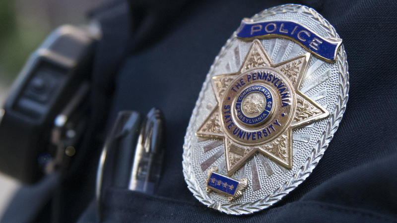 Police officer in uniform with badge featured