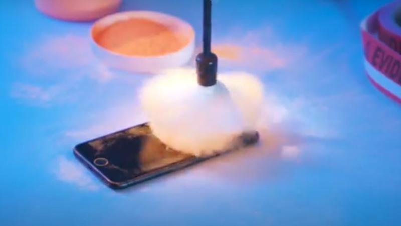 A cell phone being dusted for fingerprints