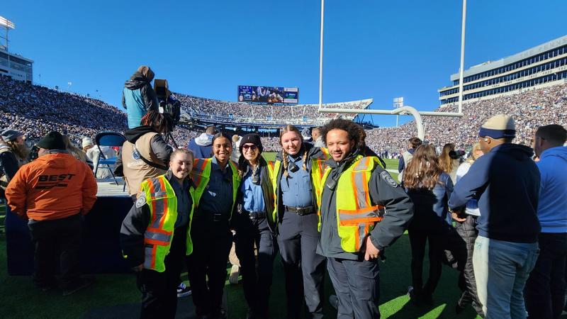 Student Auxiliary Officers standing in front of goal post at Beaver Stadium