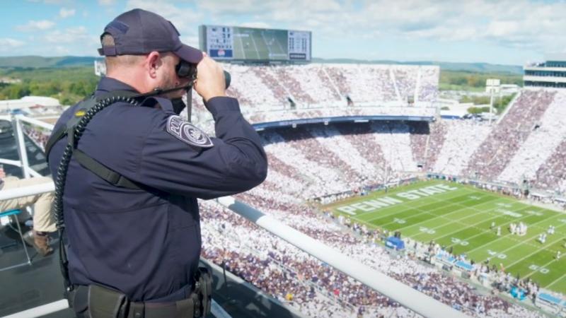 Member of TRT overlooking stadium with binoculars